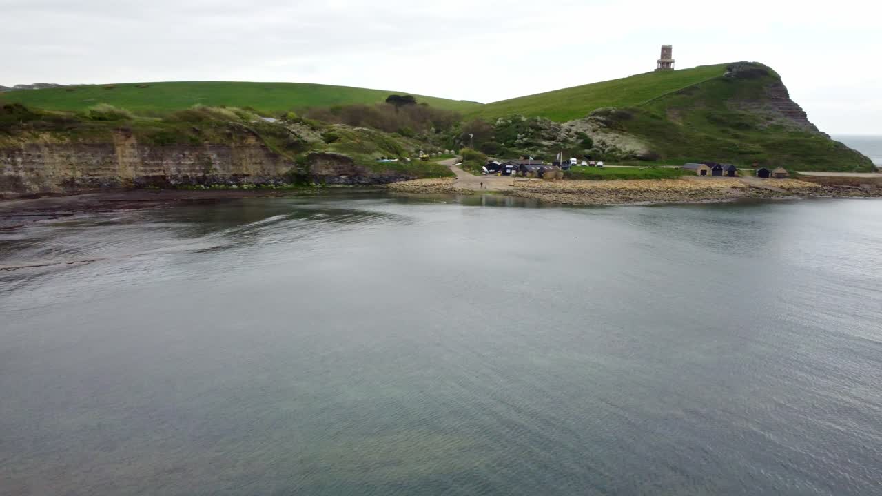Drone footage moving around Limmeridge Bay, Dorset. Rotating around from inside the bay around the edge to show the lighthouse on top of the cliff.
