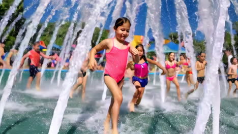 kids playing in a water fountain