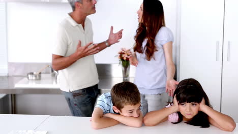 sad siblings listening to parents arguing