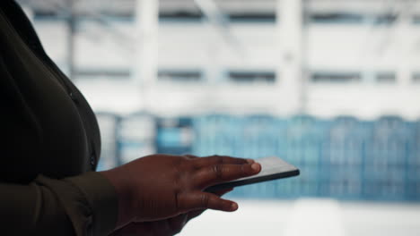 close up of data center software developer doing data analysis on tablet
