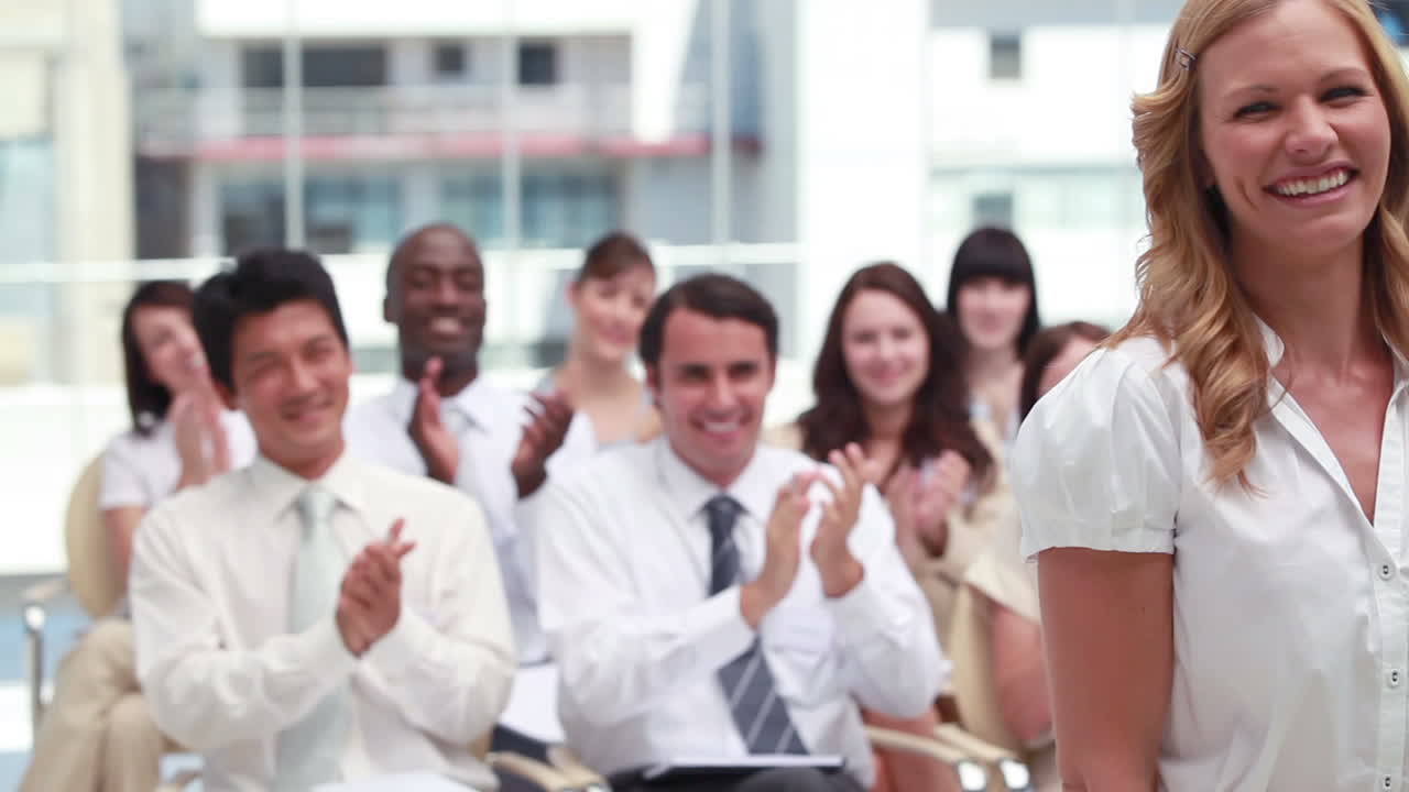 Blonde woman being applauded 