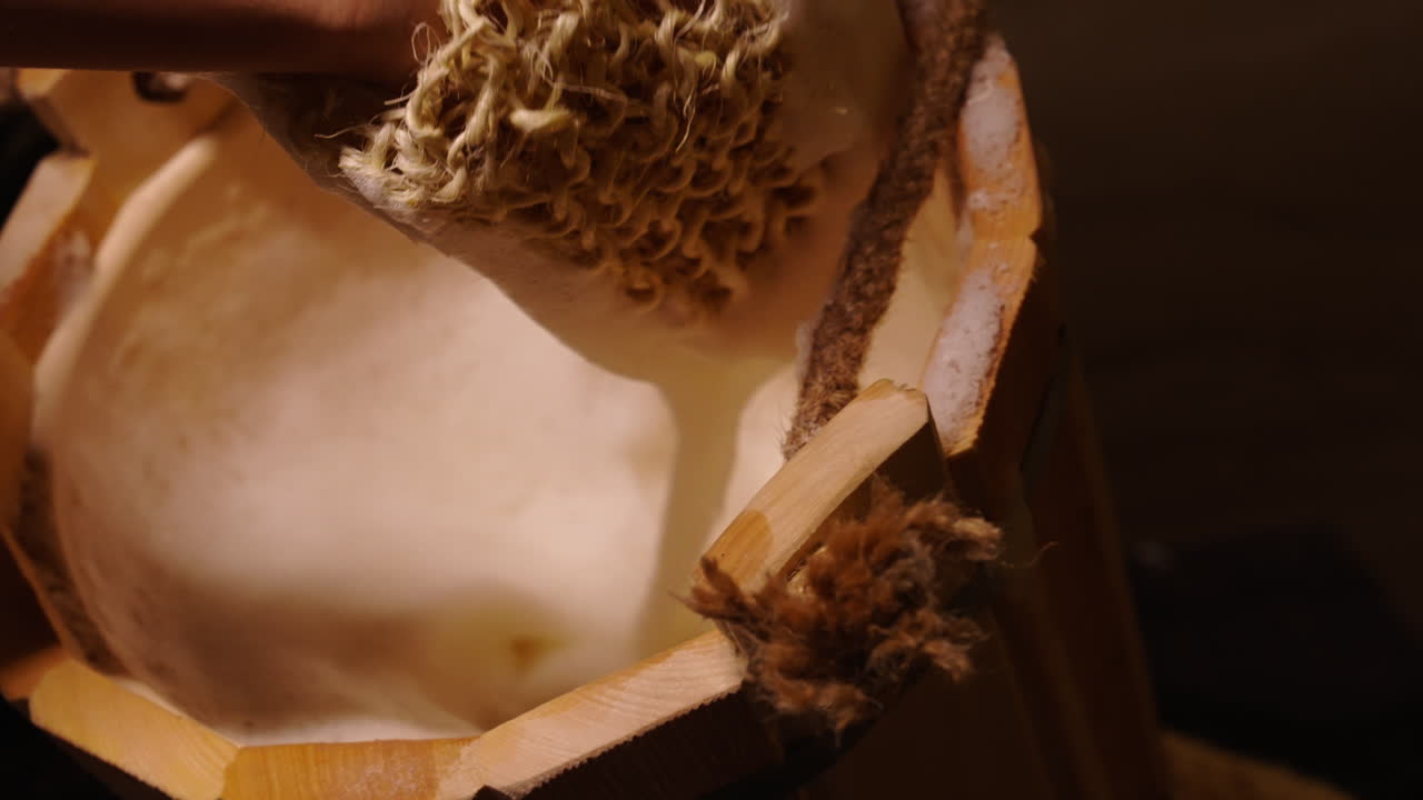 Hand Washing with Loofah in Wooden Bucket