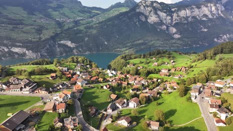 epic drone shot of canton glarus nord municipality in switzerland, showcasing lush green grass and the stunning landscape