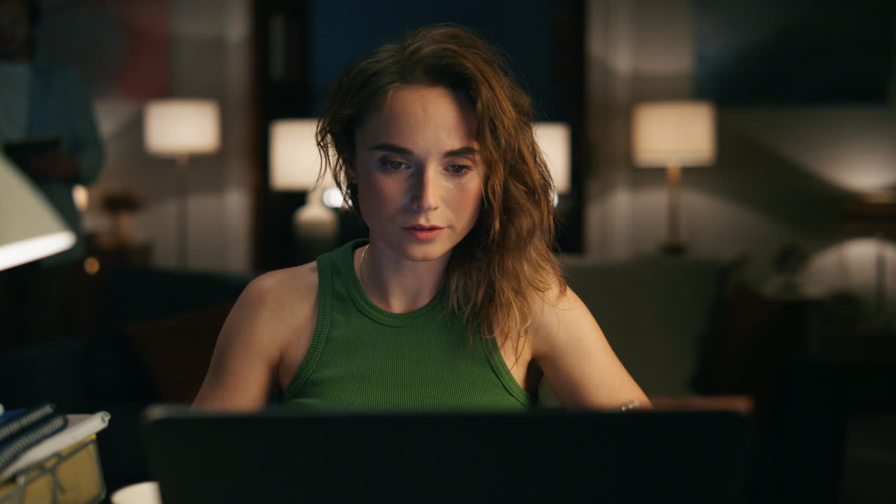 Busy woman making notes at home office closeup. Remote work girl browsing laptop