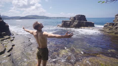 freedom man opens his arms in the sea.