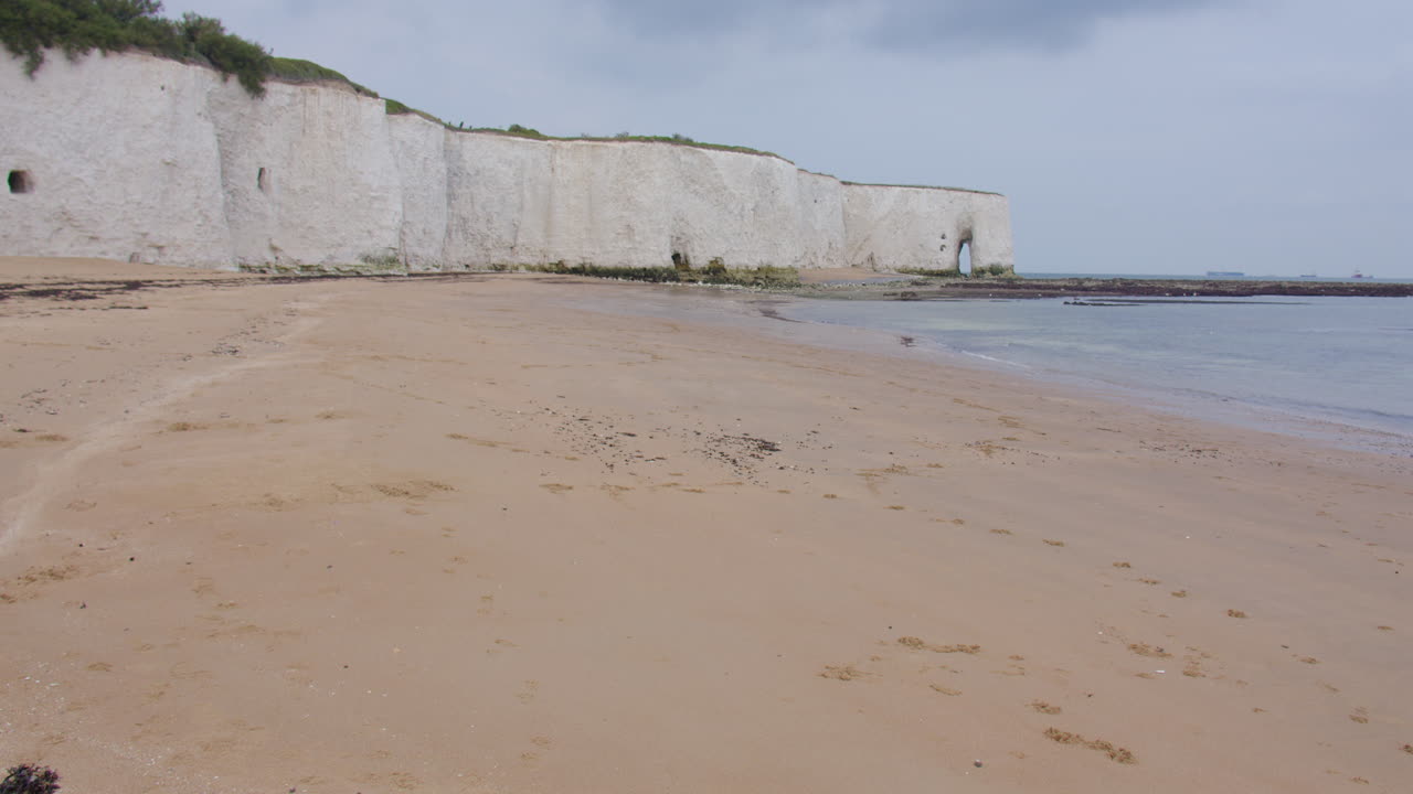 Extra wide shot of kingsgate beach with white cliffs and the King's gate arch in background at low tide