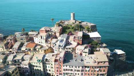 drone flies away from doria tower ruins in vernazza, cinque terre, italy