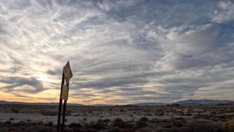 Driving-along-Highway-14-at-sunset-near-Lancaster,-California---passenger-window-point-of-view