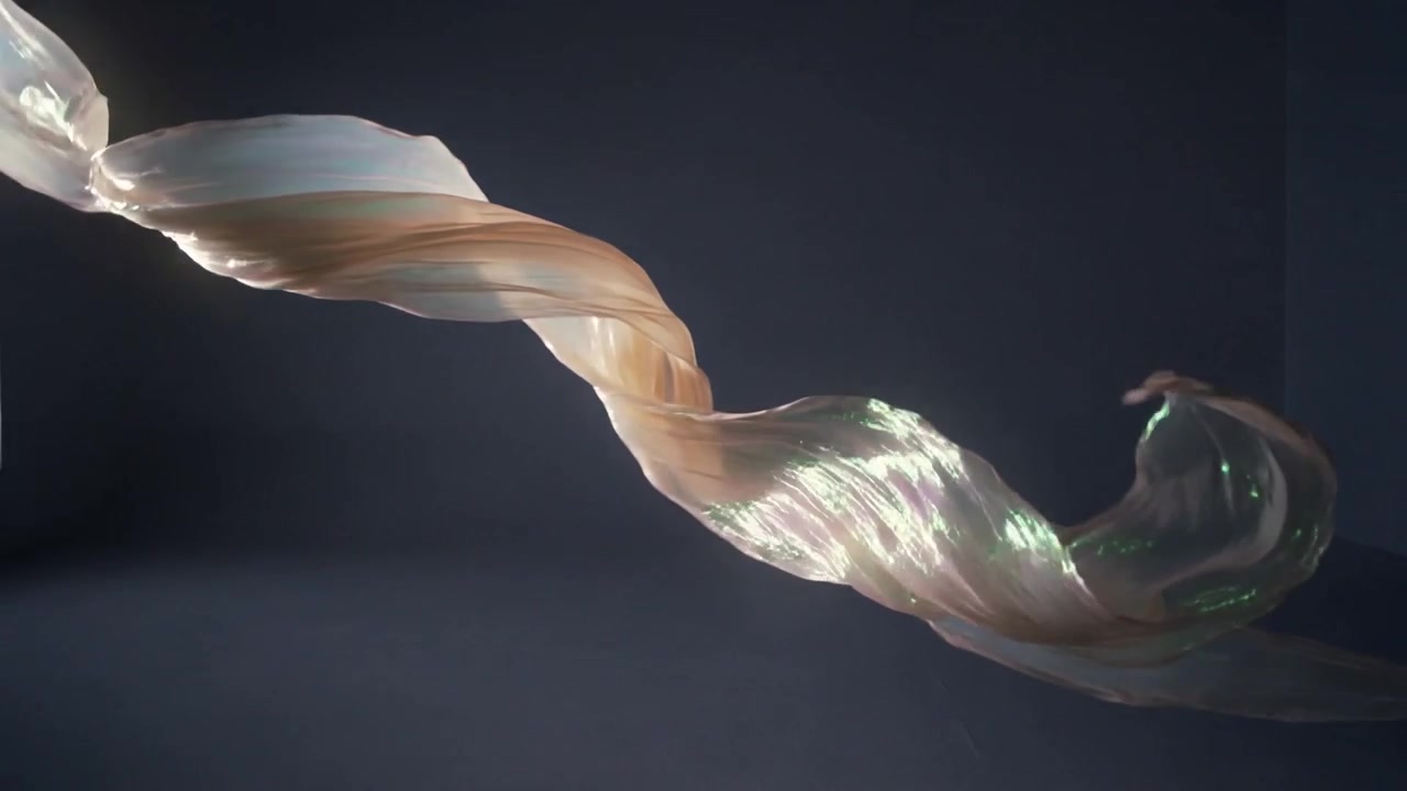 Twisting translucent ribbons moving across curved grey backdrop, responding to left window light