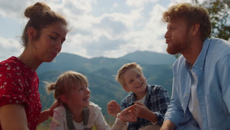 Family-have-fun-sitting-meadow-at-summer-closeup.-Parents-playing-with-children.