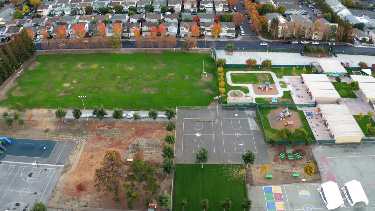 Aerial View of a School Campus with Sports Fields and Playgrounds in Autumn