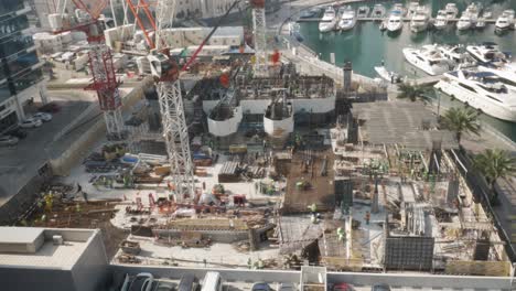 timelapse: building a skyscraper, starting from the foundation. taken in dubai marina (an affluent residential district of the united arab emirates), exterior day.