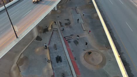 Aerial-shot-of-Boise,-Idaho's-unique-Rhodes-Skate-Park-nestled-between-highways