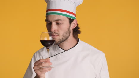 caucasian chef in front of camera on yellow background.