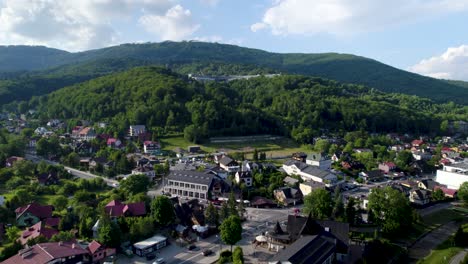 aerial view of stunning mountain town at sunny day, drone shot of "szczyrk