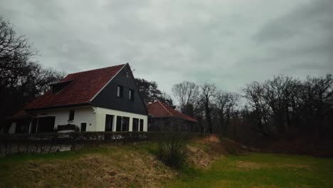 exterior of dutch countryside house with pointed roof in rural landscape