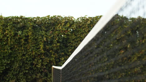 happy couple giving high five over the net after playing tennis together