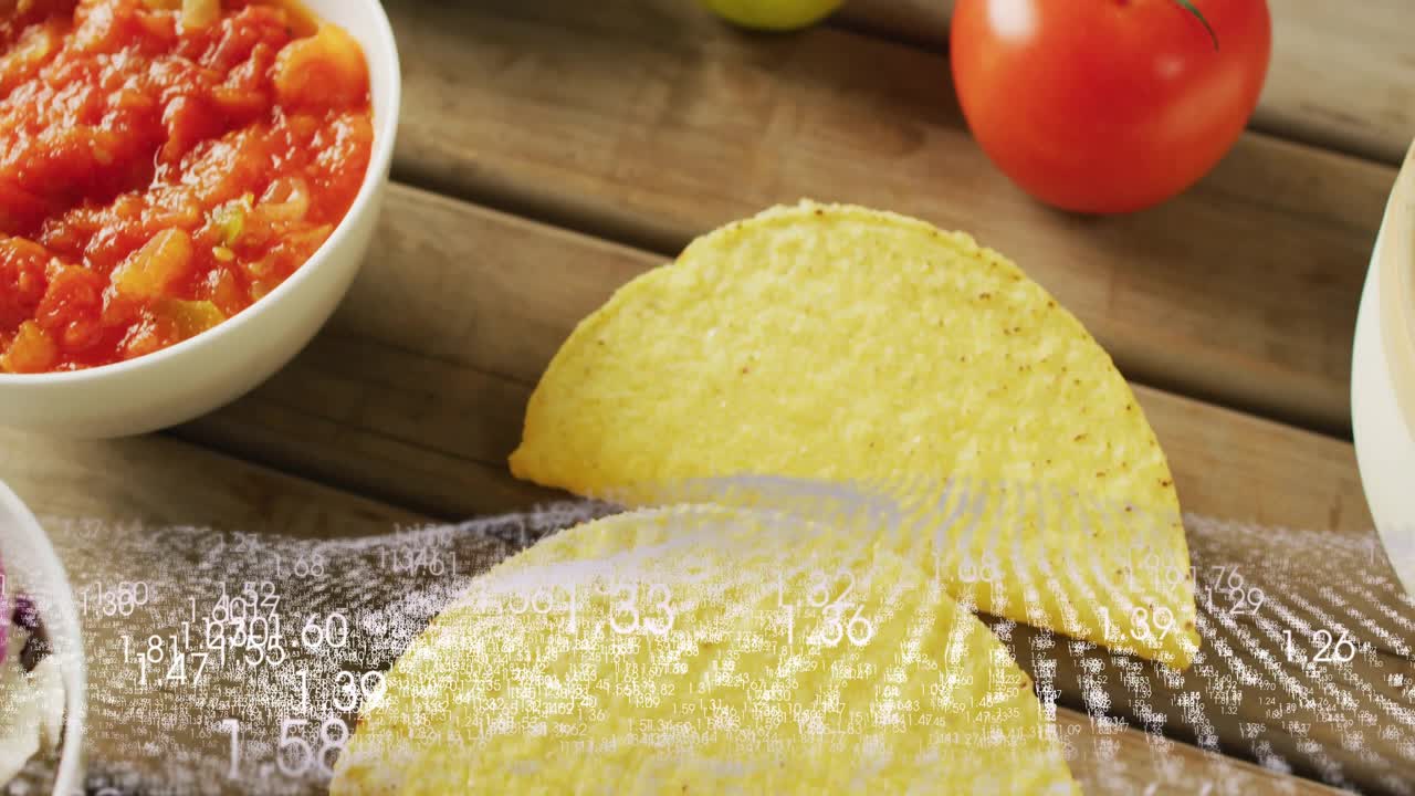 Sovrapposizione numerica che scorre, gusci di taco che si muovono mentre salsa, lime e avocado appaiono per la presentazione di un prodotto