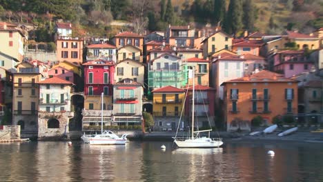 POV-from-a-boat-of-the-shores-of-Lake-Como-with-the-town-of-Varenna-and-the-Italian-Alps-in-background-2