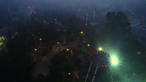 Night-aerial-view-of-the-top-of-Santa-Lucia-Hill-Pedro-de-Valdivia-Square-illuminated-by-lights-from-poles