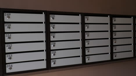 a long line of mailboxes on a brown wall