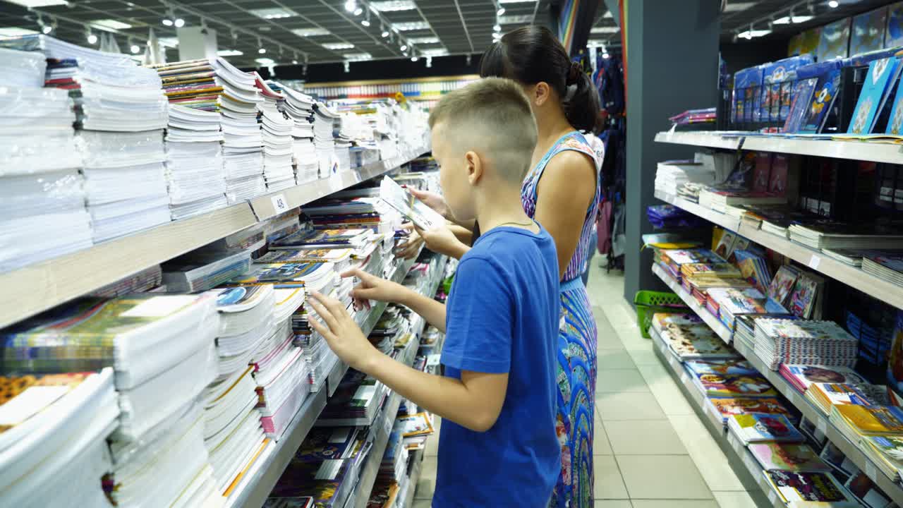 Vinnitsa, Ukraine - August, 2018: Little boy is buying stationery for school. Back to school concept.