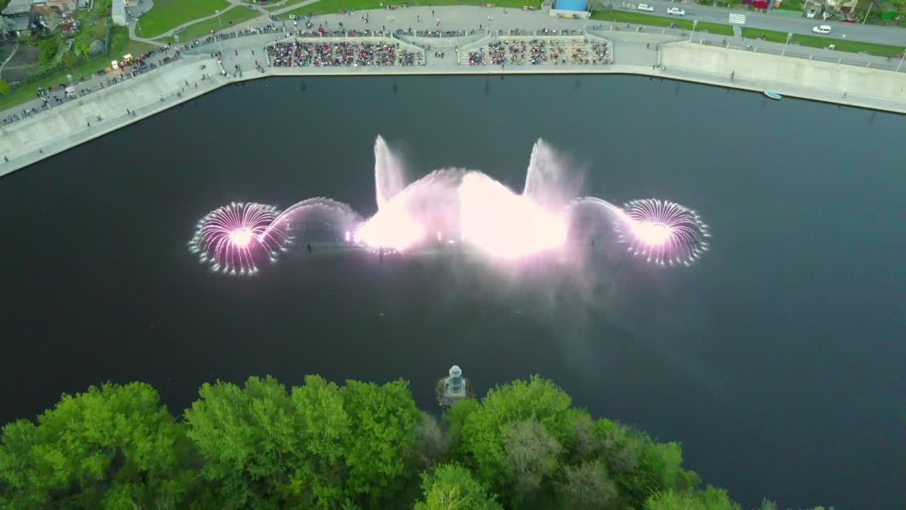 Beautiful Dancing Fountain. Aerial shot of the colorful illuminated musical fountain at dusk