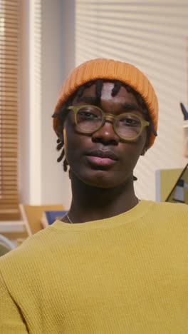 young man in a yellow sweater and orange hat