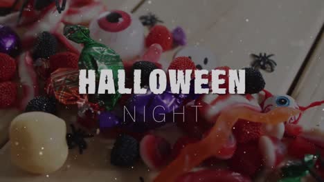 Animation-Von-Halloween-Text-über-Süßigkeiten-Auf-Holzhintergrund
