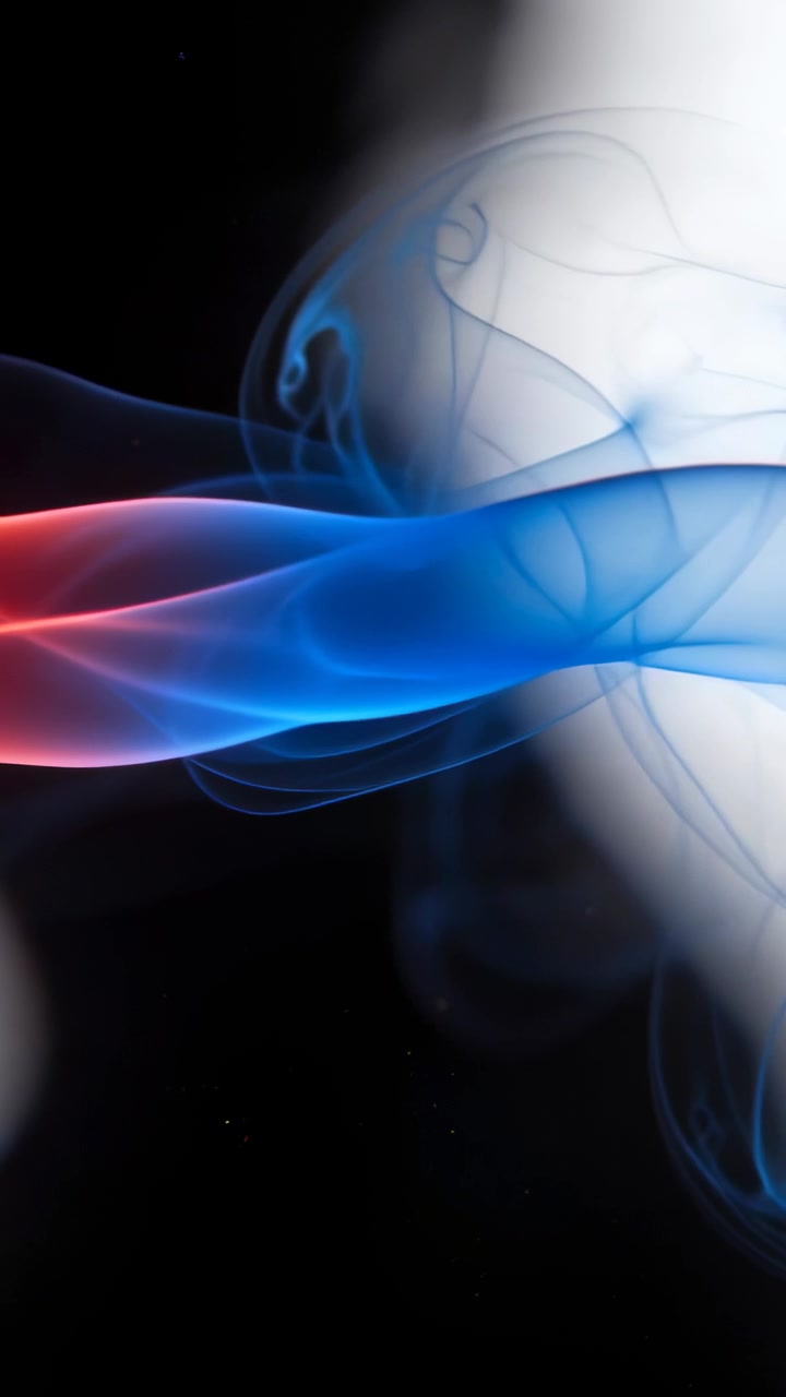 Vertical video: Entering blue-and-red smoke ribbon curling toward bright light meeting smoke bubble
