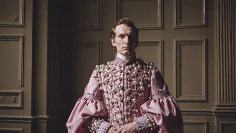 historical reenactment features a nobleman wearing an elegant pink costume, standing in a stately room with wood paneling and subtle lighting, evoking a sense of timeless grace