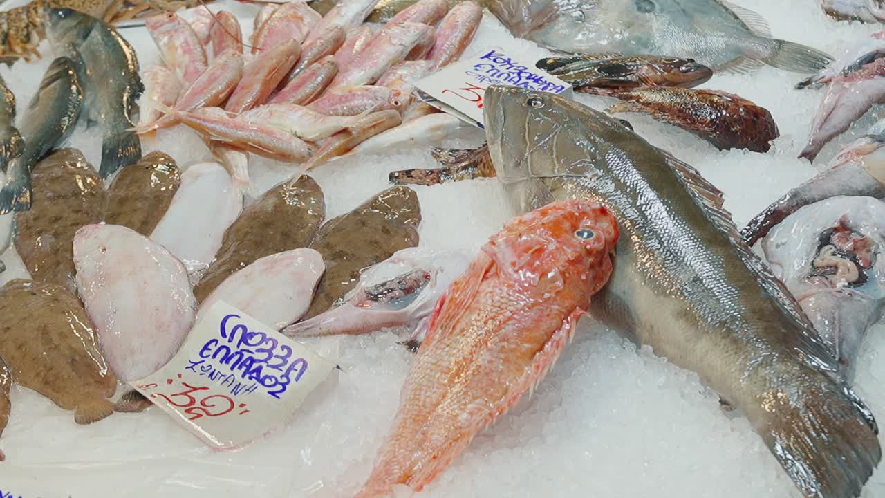 Fresh fish displayed on ice at a bustling market, vibrant seafood selection