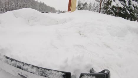 pov man shovelling snow from driveway after heavy snowfall