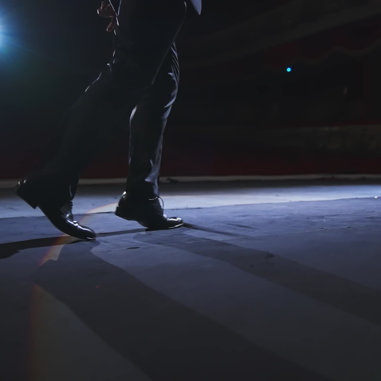 Actor dancing on stage. Man in stylish shoes and suit dances on a theater stage during the performance. Close-up.