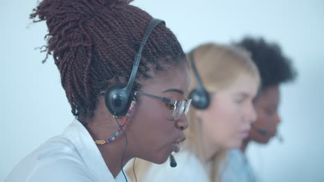 serious african american call center worker in headset