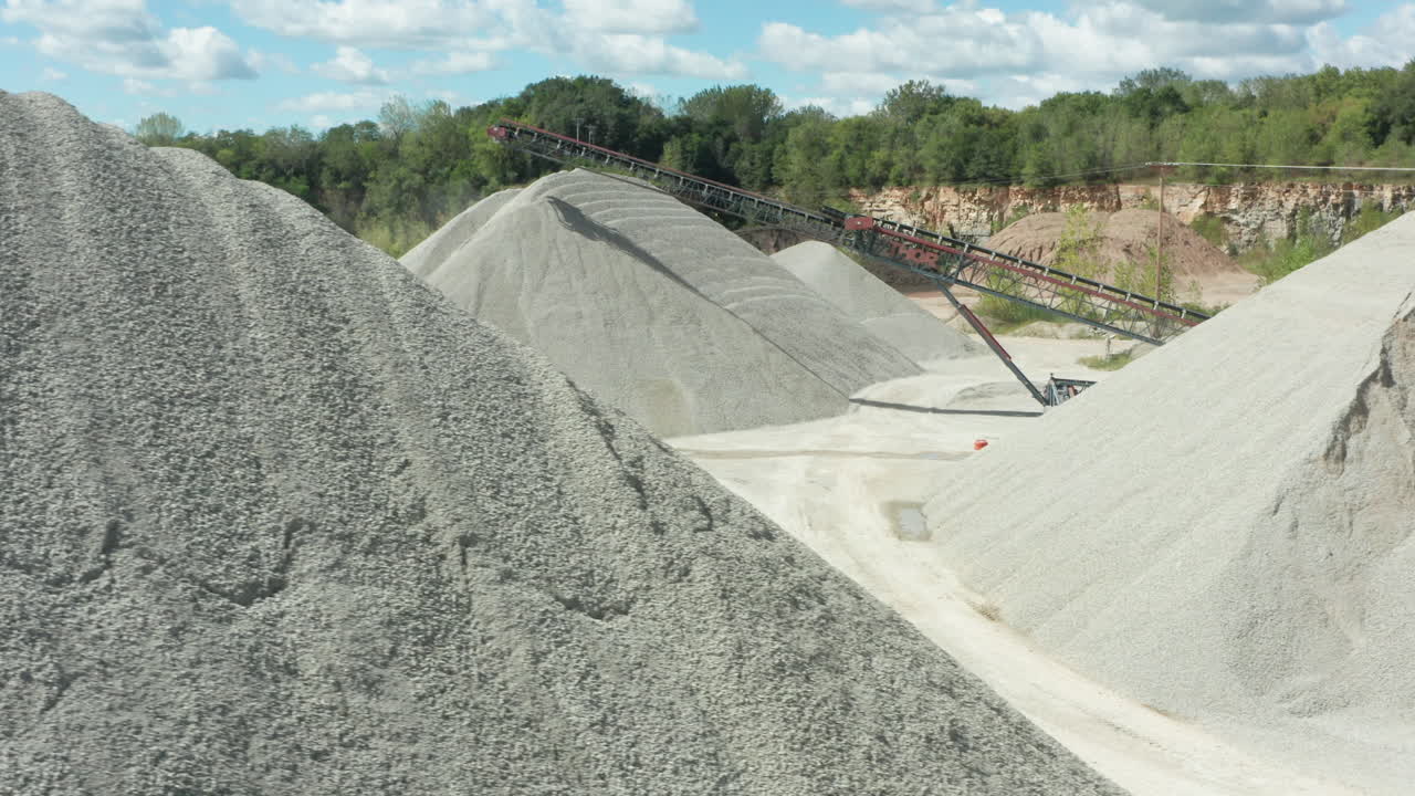 Daylight Aerial Panning of Limestone Piles and Conveyor Belt at Quarry