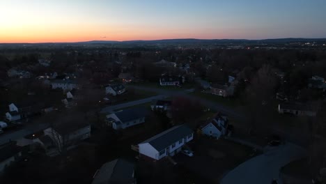 drone flight over quiet district in american town at golden sunset