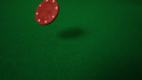 red casino chip falling towards camera
