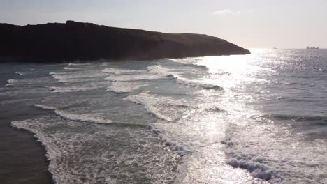 Waves-in-the-sea-with-some-surfers-aerial-view