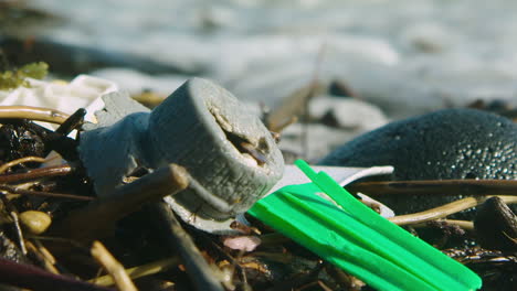 stunning shot of washed up plastic on a beach, before a wave comes and surrounds it in foamy water