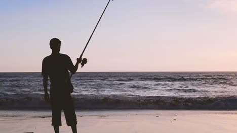 high quality silhouette man with fishing rod at bali beach when sunset time free space background sunset sky