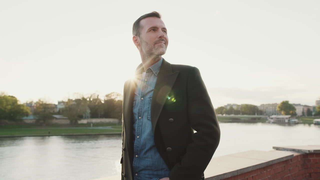 Man in coat by the river