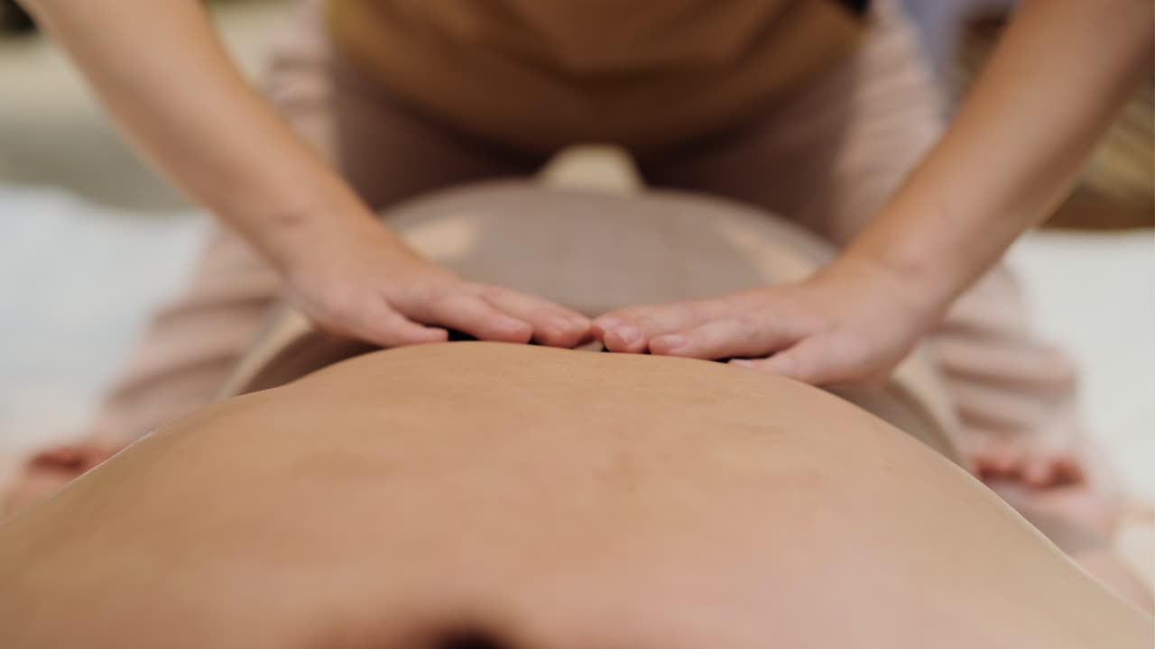 Masseuse giving massage to man
