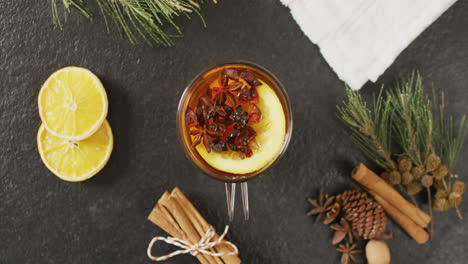 video of cup of hot tea with cinnamon and lemon over grey background