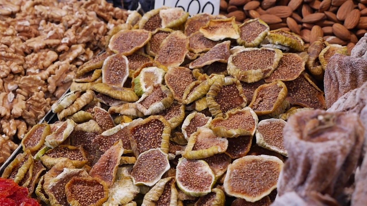 Assortment of Dried Figs and Nuts at a Market Stall