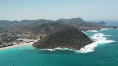 tropical shore at bay of selong belanak beach with large mountains in lombok