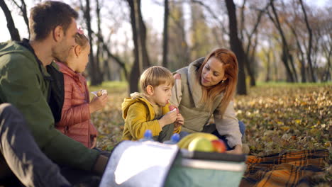 family picnic in the park during autumn