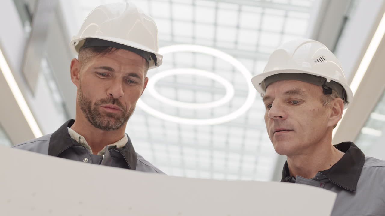 Men in Safety Helmets Talking
