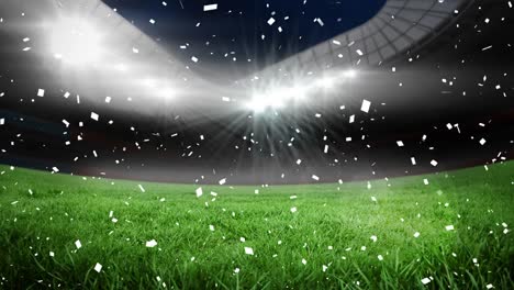 Animation-of-confetti-floating-over-sports-stadium-at-night