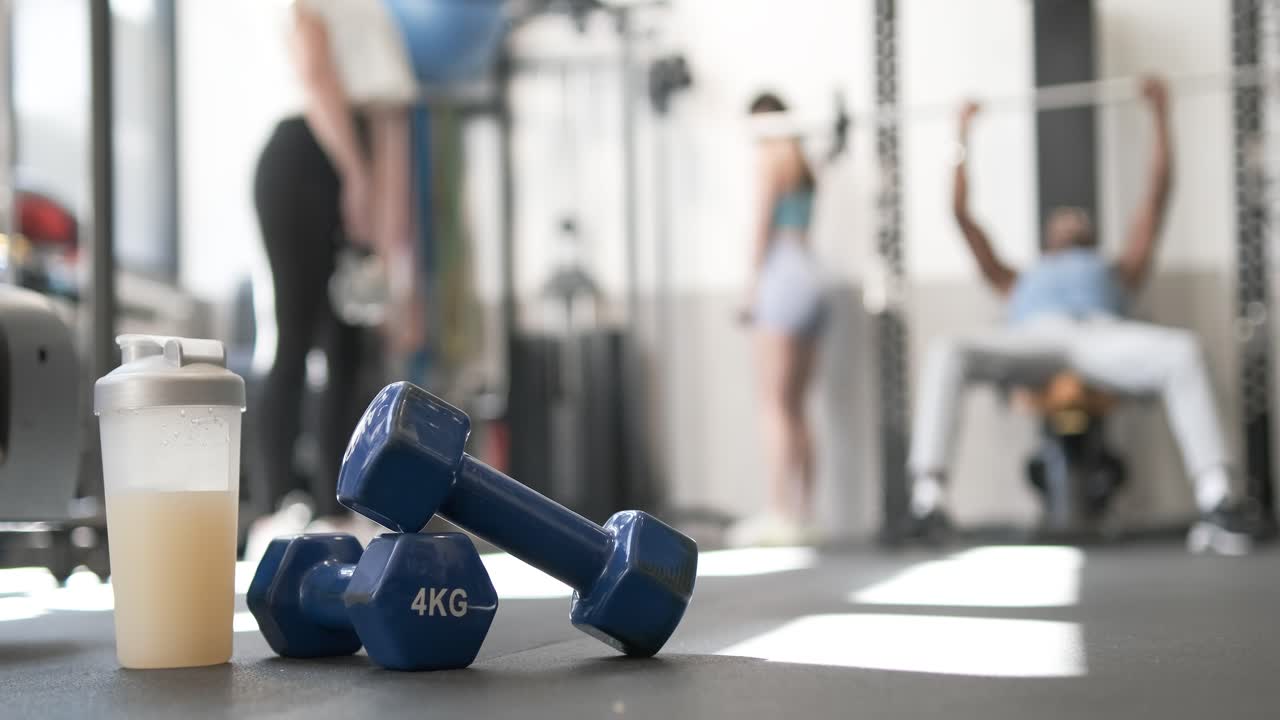 Gym Workout Scene with Dumbbells and Protein Shake